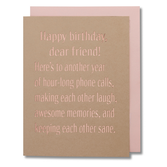 Birthday card with message 'Happy birthday, dear friend…' in rose gold foil on tan paper, shown with blush envelope