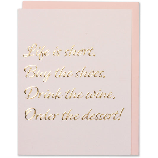 Pink birthday card with gold foil quote: "Life is short. Buy the shoes. Drink the wine. Order the dessert!" Embossed, elegant design. Blus envelope.